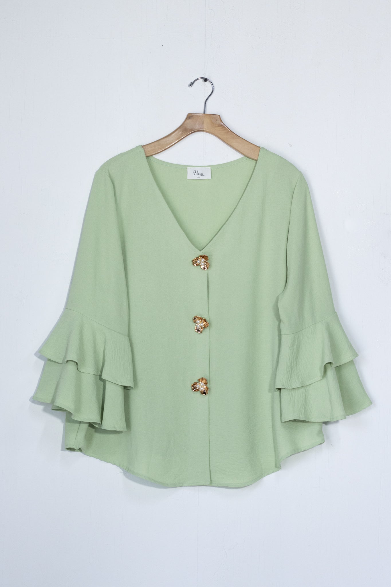 Blusa lisa botones flor