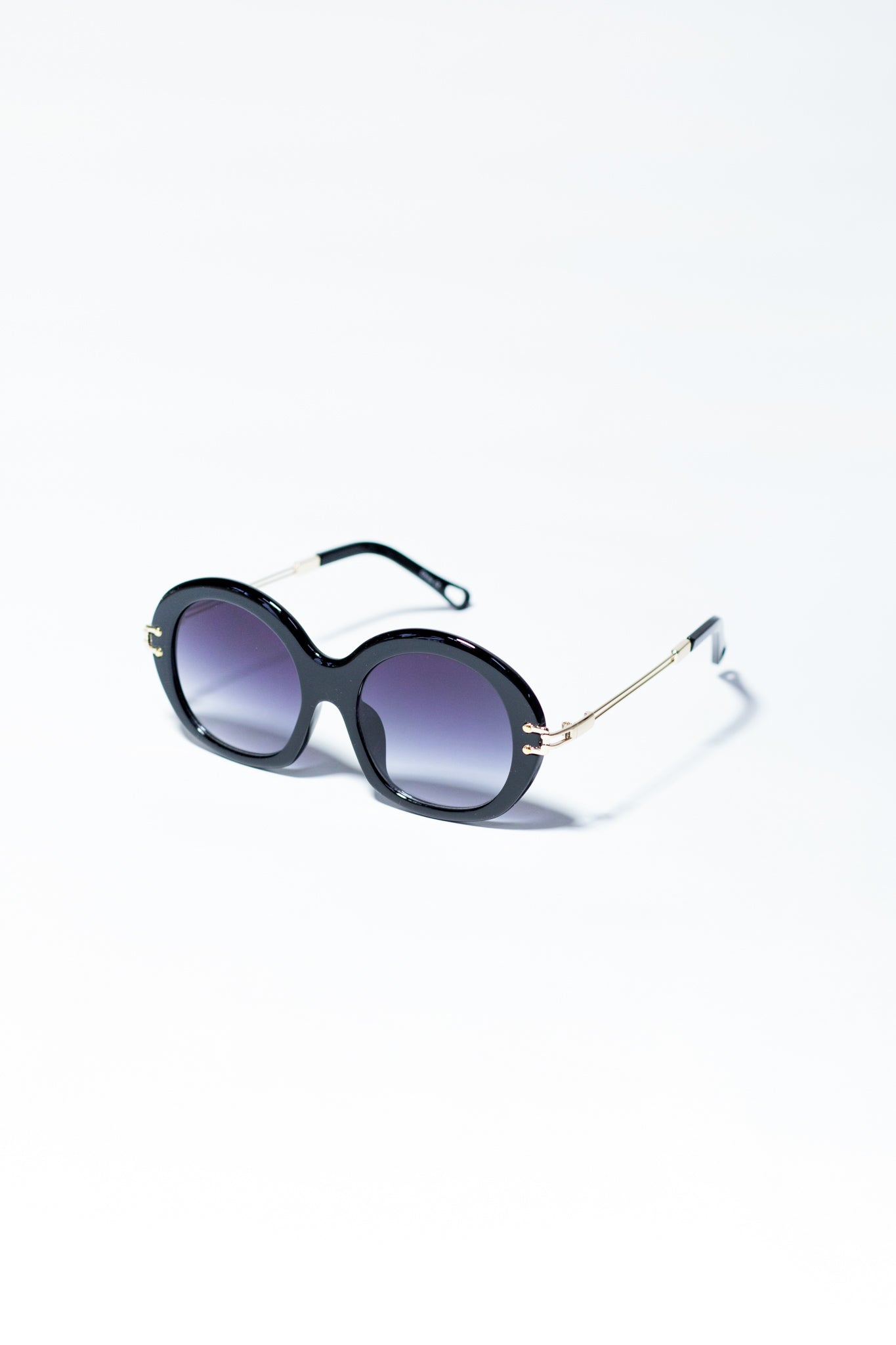 Lente redondo negro con dorado